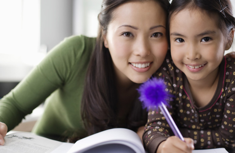 Women and child doing homework together